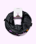 Back view of the Pusheen Bat Collapsible Tunnel in its packaging. The paper card that holds the foldable tunnel together shows an overview of the full graphic pattern on the tunnel, which includes two bats.