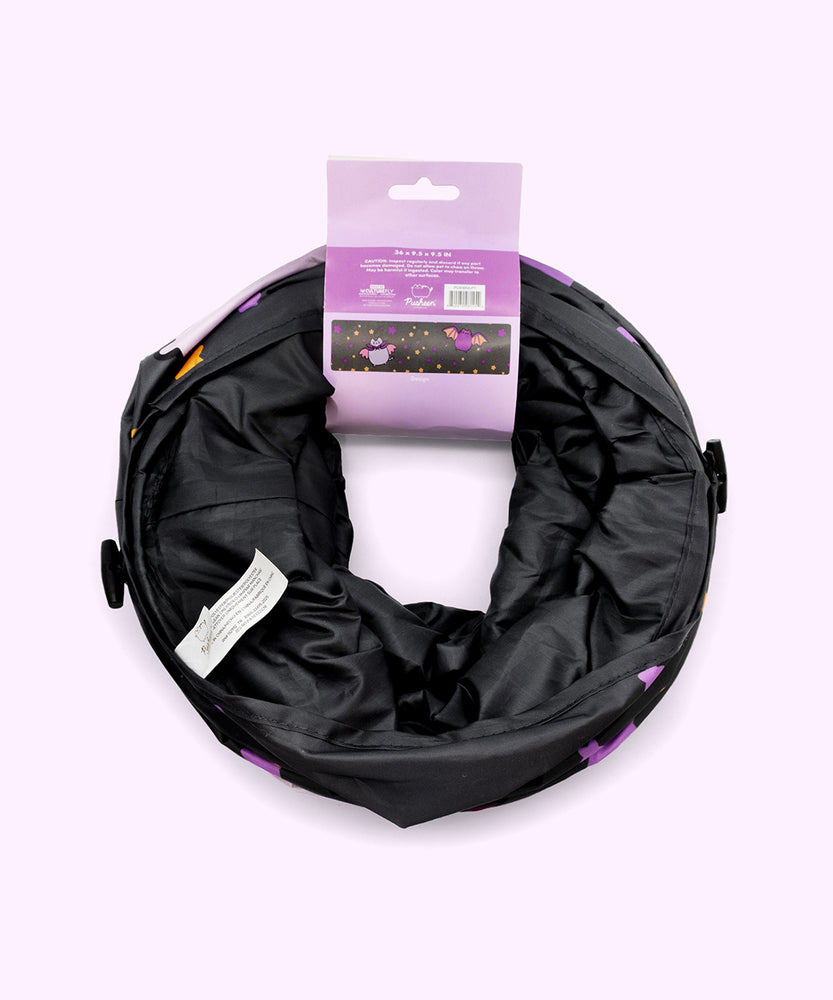 Back view of the Pusheen Bat Collapsible Tunnel in its packaging. The paper card that holds the foldable tunnel together shows an overview of the full graphic pattern on the tunnel, which includes two bats.