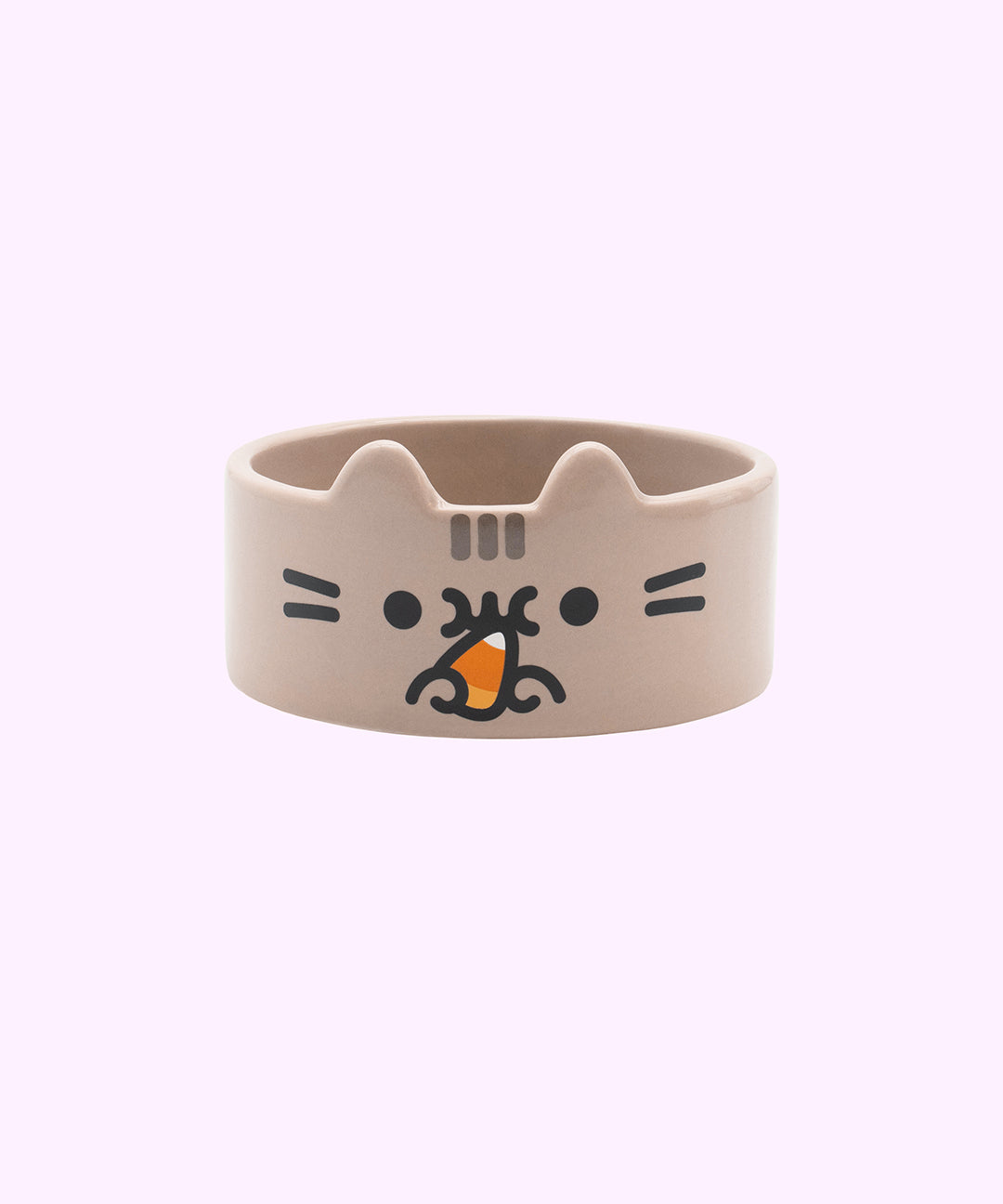 Front view of the Pusheen Pet Halloween Bowl. The ceramic pet bowl is shaped like Pusheen the Cat. The front features a graphic of Pusheen with black facial features and grey head stripes while she munches on a yellow, orange, and white candy corn.