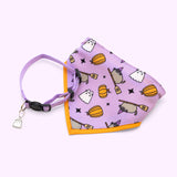 Front view of Pusheen Pet Halloween Collar & Bandana Set. The purple collar has a Boosheen charm. The bandana has an purple background and an all-over-print graphic of Pusheen as a witch riding a broom, boosheen, pumpkins, and black stars.