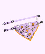 Pusheen pet Halloween-themed collar and bandana set laid out to show the length of the collars and the size of the bandana. The set rests on a light purple background. 