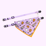 Pusheen pet Halloween-themed collar and bandana set laid out to show the length of the collars and the size of the bandana. The set rests on a light purple background. 