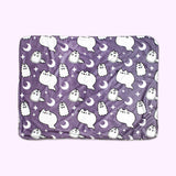 Front view of the Pusheen Pet Halloween Ghosties Blanket. The micro flannel front side features an all over print of Pusheen, Stormy, and Pip as white ghosts surrounded by white crescent moons and stars. The background of the print is purple.   