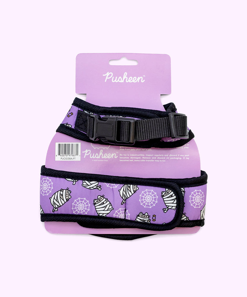 Back view of the purple pet harness with black trim attached to its paper packaging.