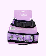 Back view of the purple pet harness with black trim attached to its paper packaging.