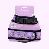 Back view of the purple pet harness with black trim attached to its paper packaging.