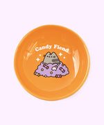 Alternate view of Halloween cat bowl. The bowl features a repeating pattern of candy corn, suckers, chocolates, and more on the base of the pedestal.