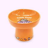 Alternate view of Halloween cat bowl. The bowl features a repeating pattern of candy on the base of the pedestal.