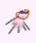 Close-up of the light purple and purple Vampurr plush pet toy with pink feathers and grey ribbons attached to the bottom. 