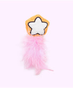 Close-up of the orange and white star plush pet toy with pink feathers attached to the bottom. 