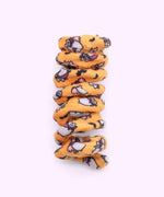 Close-up of orange spiral cat toy that has a pattern of Vampurr Pusheen with black bat graphics.