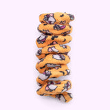 Close-up of orange spiral cat toy that has a pattern of Vampurr Pusheen with black bat graphics.