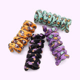 Pusheen Halloween Pet Spiral Toys 4-Pack includes orange, purple, black, and mint green spiral toys with all over patterns of Pusheen and Halloween elements. 