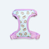 Under view of the Pusheen Pet Harness. The interior is light blue with an all over pattern of three Pusheens and yellow, pink, purple, and white stars. The Pusheen poses show the cat waving, loafing, jumping, and standing.