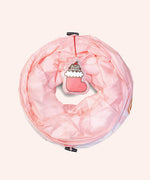 Collapsible Pet Tunnel folded into a thin circle. The plush dangle is shown on top of the light pink pet toy.