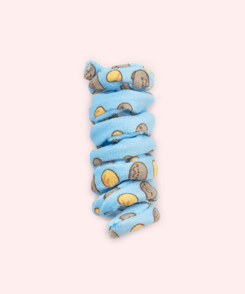Close-up of blue spiral cat toy that has a pattern of Pusheen the Cat in a loaf pose with a yellow loaf of bread. 