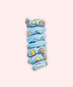 Close-up of blue spiral cat toy that has a pattern of Pusheen the Cat in a loaf pose with a yellow loaf of bread. 
