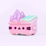 Front and side view of the vinyl figure in collaboration with 100% Soft and Dumpster Fire. The small Pusheen collectible stands on four legs, has a fuzzy light pink body, and pastel-purple flames extending off the top of the toy. 