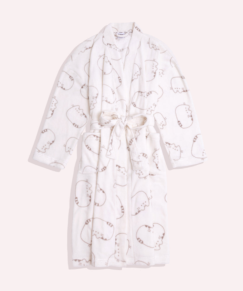 Pusheen Plush Robe hangs on a hanger and shows a close-up of the all over gray cat print on the cream fabric. 