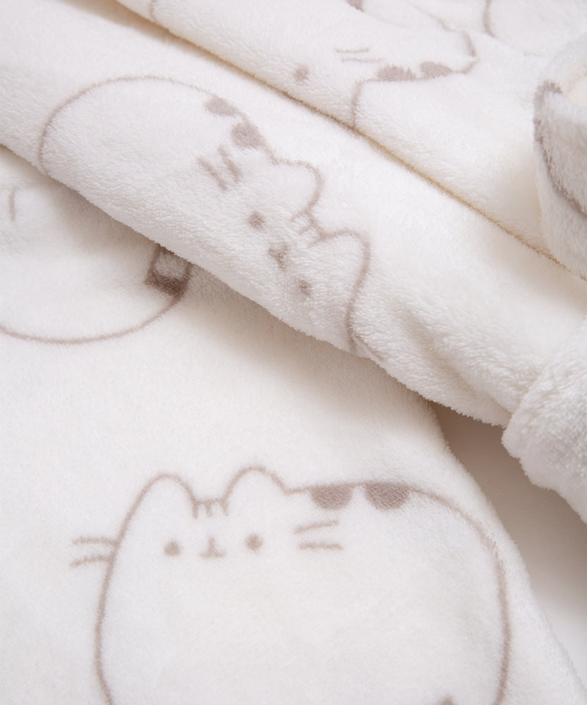 Close-up of plush fabric print. Pusheen the cat's ears, head stripes, eyes, mouth, and whiskers are shown in every pattern.