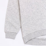 A close-up view of the cuff and hem of the Pusheen Sweatshirt. The light gray sweatshirt has tapered, ribbed detailing on the cuff and hem of the hoodie. 