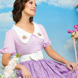 Model wearing Pusheen Springtime Blouse in front of a spring styled background. The graphics of Pusheen surrounded by flowers are featured on the oversized white lapels.
