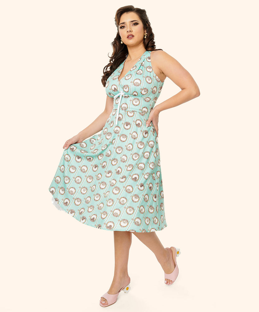 Different model wearing the Pusheen Springtime Halter Dress. The mint green dress falls past the wearer's knees. Beneath the halter top is a small white bow.