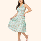 Different model wearing the Pusheen Springtime Halter Dress. The mint green dress falls past the wearer's knees. Beneath the halter top is a small white bow.
