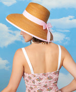 Back view of the model wearing the Springtime Romper. The Pusheen printed pink romper has a ruched panels on the top portion. 