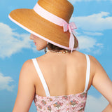 Back view of the model wearing the Springtime Romper. The Pusheen printed pink romper has a ruched panels on the top portion. 