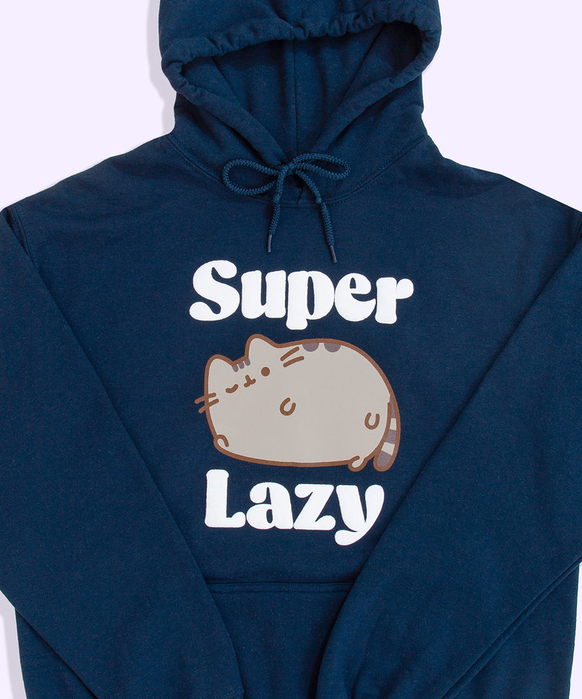 A close-up view of the Pusheen Super Lazy Unisex Hoodie screen print graphic. The brown and grey cat is lounging and winking while claiming she’s “super lazy”. 