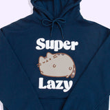 A close-up view of the Pusheen Super Lazy Unisex Hoodie screen print graphic. The brown and grey cat is lounging and winking while claiming she’s “super lazy”. 