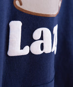 Close-up view of the puff print on the navy hoodie. The white phrase “Super Lazy” has the puff print effect on this Pusheen Super Lazy hoodie. 