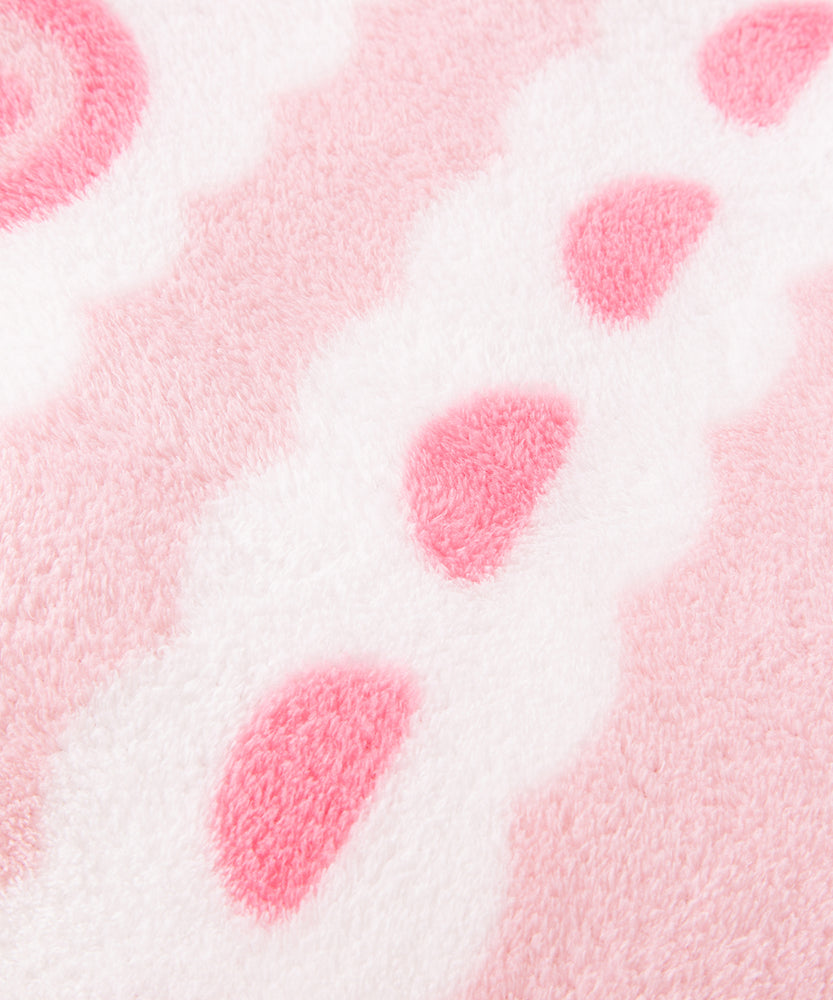 Close-up of the polyester material on the sweet blanket. The border shown features a white scalloped detail with medium pink colored gum drops.