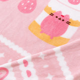 Close-up view of the polyester fabric on the Pusheen Sweet Blanket. The soft pink fabrice has white, medium pink, and light pink graphic details around the border.