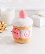 Alternate side quarter view of the Pusheen Sweets Strawberry Plush Environment. The white, pink, and brown plush has a removable miniature plush of Pusheen the Cat.  