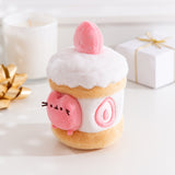 Alternate side quarter view of the Pusheen Sweets Strawberry Plush Environment. The white, pink, and brown plush has a removable miniature plush of Pusheen the Cat.  