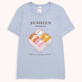 Blue t-shirt with a large graphic on the front center. The graphic shows Pusheen the Cat as four different types of macaron flavors placed in a box.