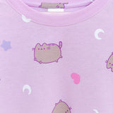   A close-up of the all over print graphic on the front-center of the light purple, unisex pajama top. The grey tabby cat is outlined in a medium surprise and has purple eyes, mouth, stripes and whiskers. 