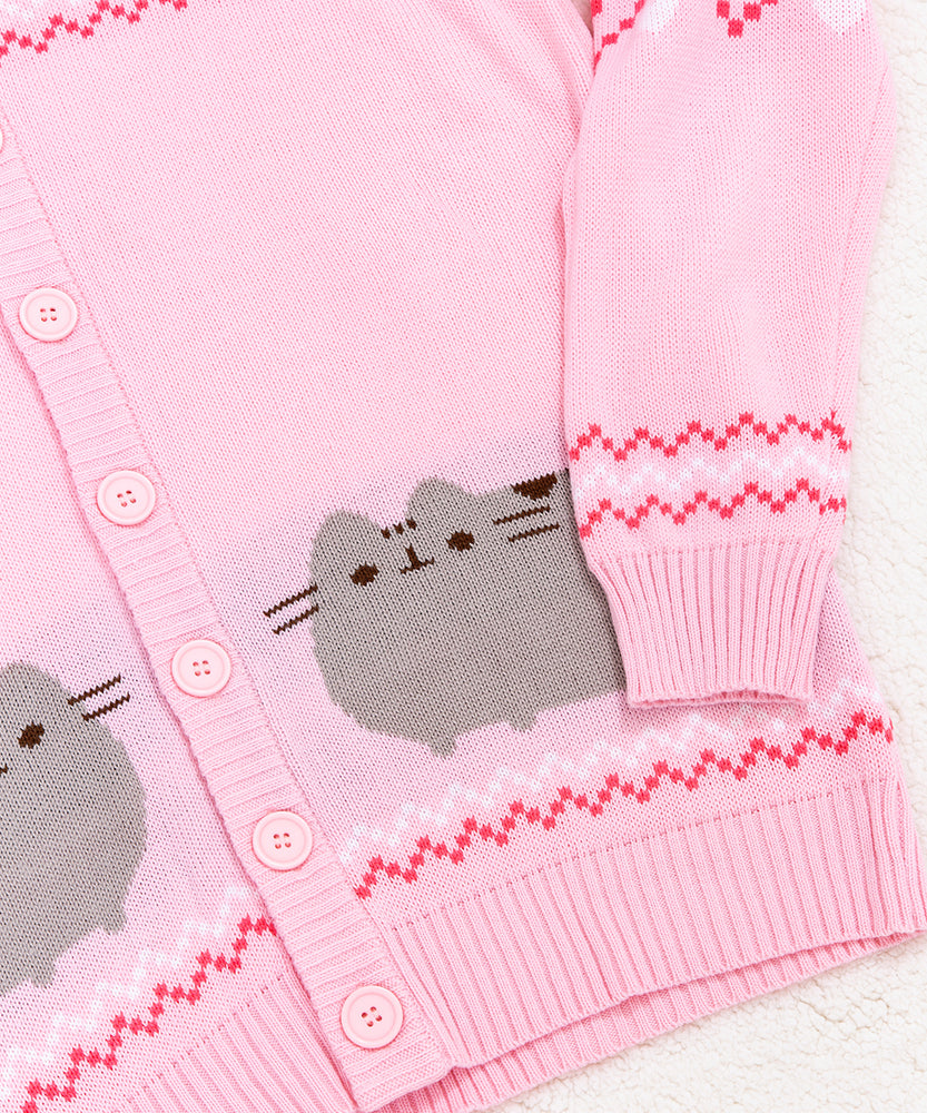 Close-up view of Pusheen knit detail. Also featured in the photo is a close-up of the cuff and hem of the pink unisex knit cardigan. The cuff and hem have a pink ribbed edge that matches the rest of the cardigan color.  