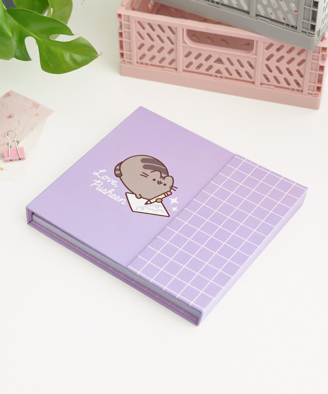 Front cover of the weekly planner. The purple binder features a graphic of a gray and brown cat writing a note with the phrase "love, Pusheen" underneath the cat.