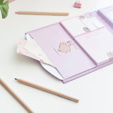 Close-up of the interior envelope pocket on the left side of the binder. The envelope can hold spare sheets of paper and can close with a slot feature. 