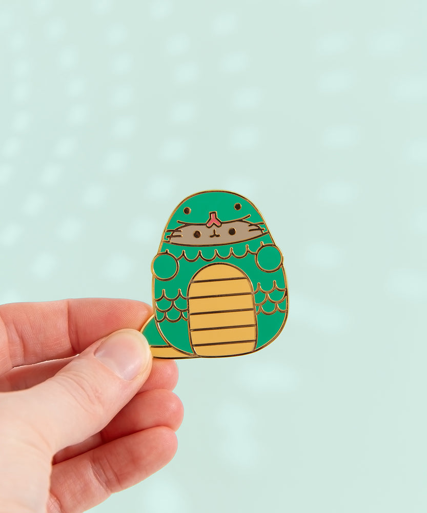 Pusheen Year of the Snake Pin. Pusheen wears a yellow and green snake costume. The green snake has yellow belly and tail details. The middle of the pin has scale details in gold plating.