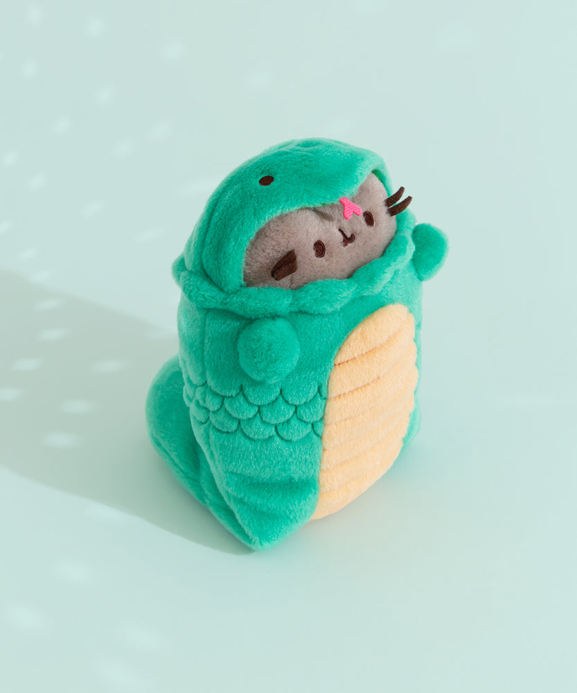 Front quarter view of the snake plush. The snake costume's pink tongue and Pusheen's brown whiskers extend off the front sides of the plush and can be seen from many angles.