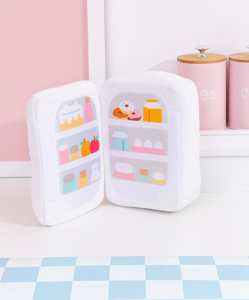 Interior view of the fridge plush. The plush opens to reveal a printed stocked fridge of Pusheen's favorite snacks. Included in the interior prink are cakes, donuts, fruits, eggs, and more!