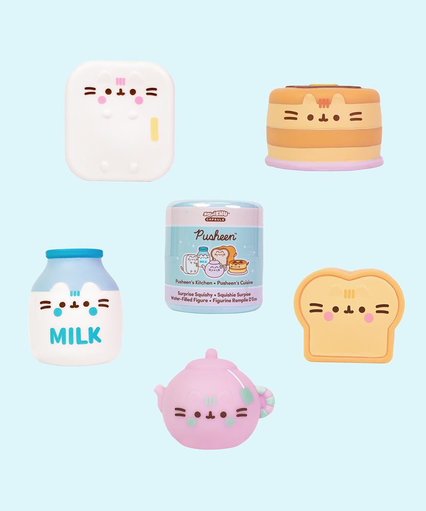 Pusheen's Kitchen Surprise Squishies surrounding the packaging capsule that each squishy comes in. The five squishys each stand around 2" tall.