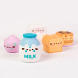 Close-up view of the milk bottle Surprise Squishy. On each squishy, Pusheen's ears partially extend off the front of the figure above the printed features of Pusheen's face.