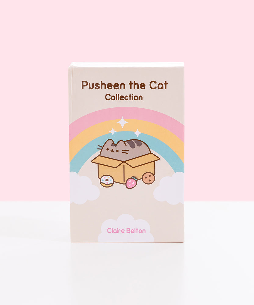 Front view of the Pusheen the Cat Collection: 3-Book Boxed Set. The decorative has a gold gift bow sitting atop the storage box with a Pusheen the Cat graphic.
