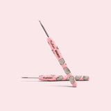 Close-up of the custom crochet hook. The pink handle features an all over print of Pusheen the Cat and the Pusheen x The Woobles collaboration logo. 