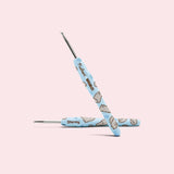Close-up of the custom crochet hook. The light blue handle features an all over print of Pusheen's sister Stormy and the Pusheen x The Woobles collaboration logo.
